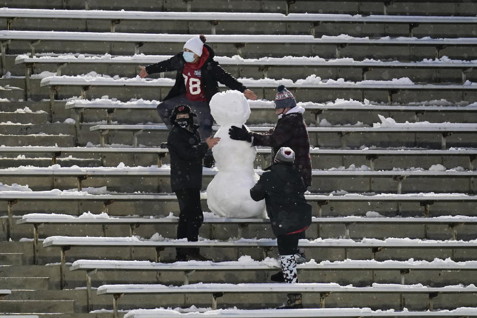 Fans build a snowman in the stands during the second half of an NCAA college football game between Iowa and Wisconsin, Saturday, Dec. 12, 2020, in Iowa City, Iowa. Iowa won 28-7. (AP Photo/Charlie Neibergall)