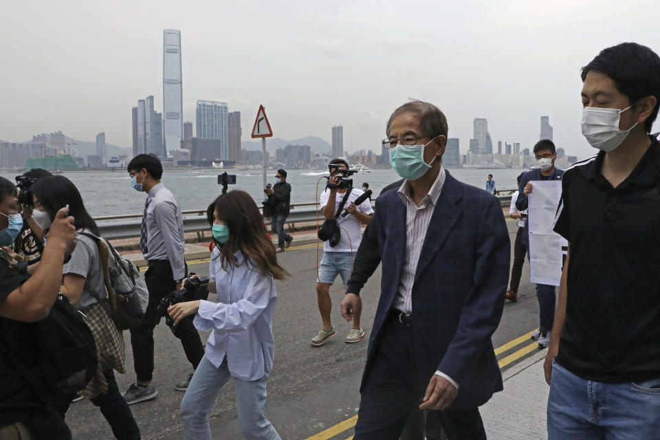 Former pro-democracy lawmaker Martin Lee, 81-year-old, second right, leaves a police station in Hong Kong, Saturday, April 18, 2020. Hong Kong police arrested at least 14 pro-democracy lawmakers and activists on Saturday on charges of joining unlawful protests last year calling for reforms. (AP Photo/Kin Cheung)