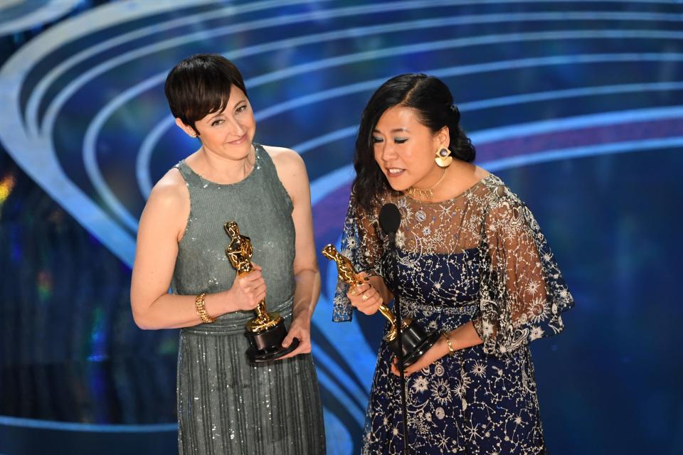 Best Animated Short Film nominees for ‘Bao’ Domee Shi (R) and Becky Neiman-Cobb accepts the award for Best Animated Short Film during the 91st Annual Academy Awards at the Dolby Theatre in Hollywood, California on February 24, 2019. (Photo by VALERIE MACON/AFP/Getty Images)