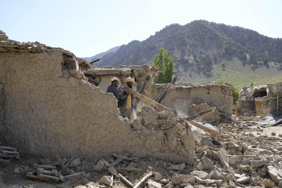 Men clean up rubble after an earthquake in Gayan village, in Paktika province, Afghanistan, Friday, June 24, 2022. A powerful earthquake struck a rugged, mountainous region of eastern Afghanistan early Wednesday, flattening stone and mud-brick homes in the country's deadliest quake in two decades, the state-run news agency reported. (AP Photo/Ebrahim Nooroozi)