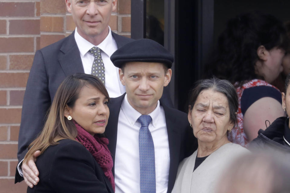 Colin Haynie, center, following the funeral for his wife Consuelo Alejandra Haynie, daughters 12-year-old Milan and 15-year-old Alexis and 14-year-old son Matthew Friday, Jan. 24, 2020, in Grantsville, Utah. Friends and family gathered Friday afternoon in a small Utah town for a funeral to remember a mother and three of her children who police say were killed by her teenage son. Colin "CJ" Haynie, 16, shot his father in the leg before the older man wrestled a handgun away, prosecutors said in court documents. (AP Photo/Rick Bowmer)