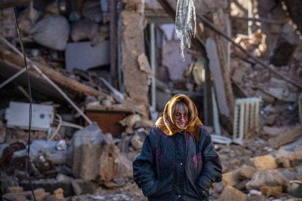 A woman stands next to the remains of a residential building that was destroyed by a Russian missile (Carl Court / Getty Images)