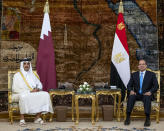 In this photo made available by Qatar News Agency, QNA, Qatari Emir Tamim bin Hamad Al Thani, meets with Egyptian President Abdel-Fattah el-Sissi, at the presidential palace in Cairo, Egypt, Saturday, June 25, 2022. Qatar's emir arrived in Cairo to hold talks with Egypt's president in his first visit since the two countries agreed to reset relations after more than seven years of diplomatic animosity. (QNA via AP)