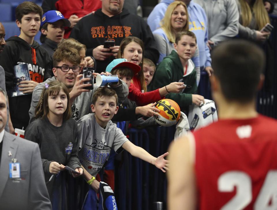 Fans greet Wisconsin guard Bronson Koenig (24) after a victory over Villanova in a second-round men's college basketball game in the NCAA Tournament, Saturday, March 18, 2017, in Buffalo, N.Y. (AP Photo/Bill Wippert)