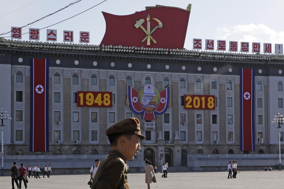 Residents walk past decoration prepared ahead of the 70th anniversary of North Korea's founding day in Pyongyang, North Korea, Friday, Sept. 7, 2018. North Korea will be staging a major military parade, huge rallies and reviving its iconic mass games on Sunday to mark its 70th anniversary as a nation. (AP Photo/Kin Cheung)