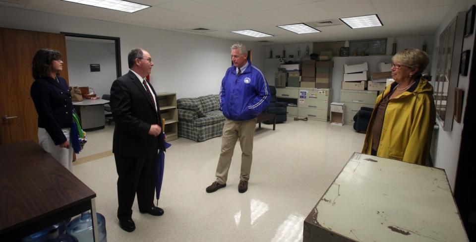 In 2015, Falmouth town officials tour fire and police department spaces under consideration for a consolidated dispatch center. Town Manager Julian Suso, center left, discusses the space with Select Board member Doug Jones.