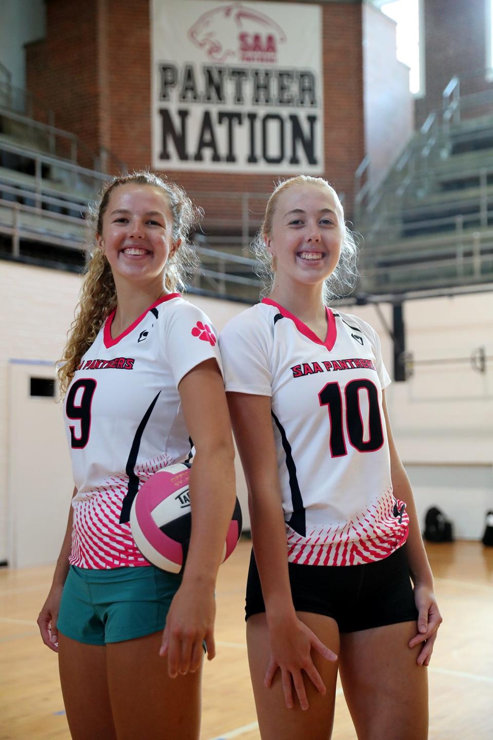 Sisters Finn and Torrin Higginbotham are known as the "twin towers" on the Savannah Arts Academy volleyball team.