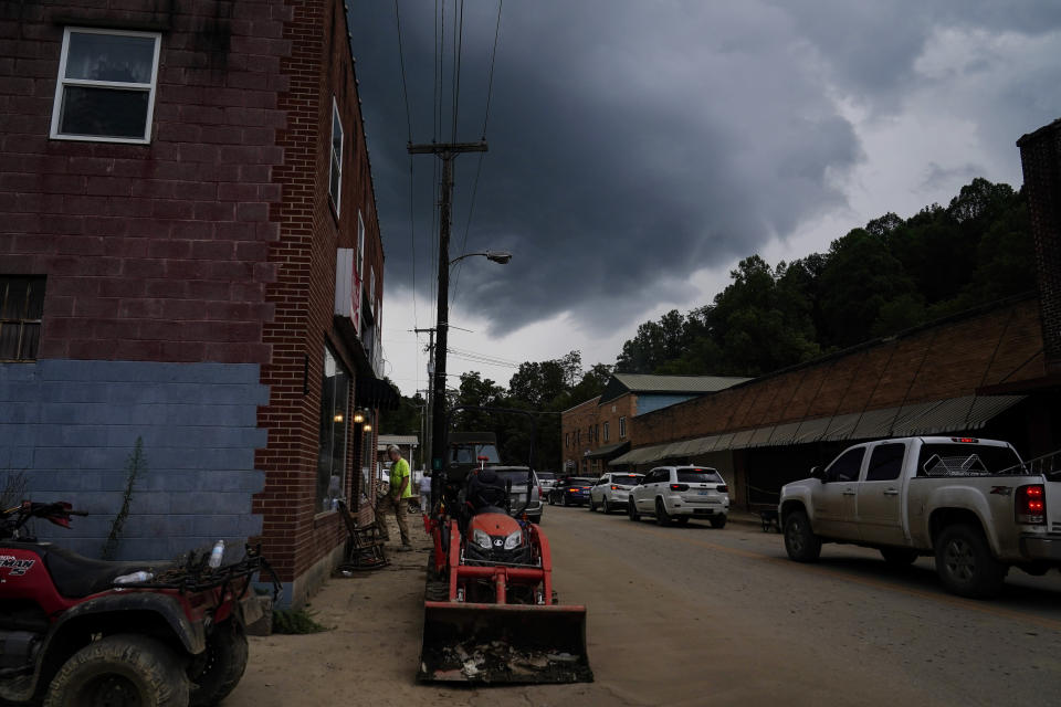 Jeff Hawkins walks into his fathers shop as the town starts to evacuate on Friday, Aug. 5, 2022, in Fleming-Neon, Ky. After massive flooding occurred the town is on high alert with storms. (AP Photo/Brynn Anderson)
