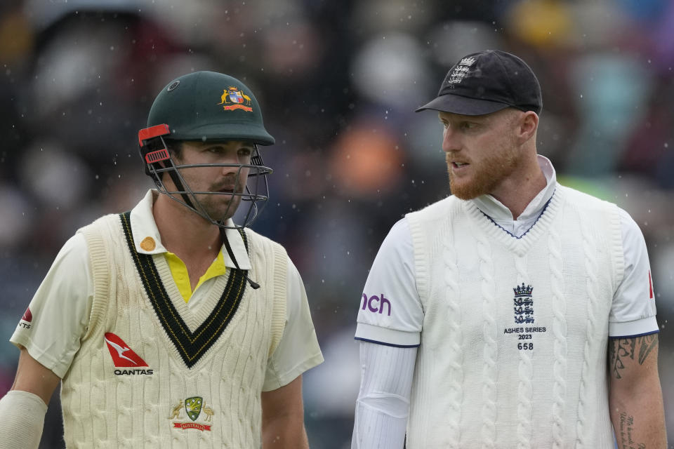 England's Ben Stokes, right, and Australia's Travis Head leave the pitch as rain delays play after lunch on day five of the fifth Ashes Test match between England and Australia, at The Oval cricket ground in London, Monday, July 31, 2023. (AP Photo/Kirsty Wigglesworth)