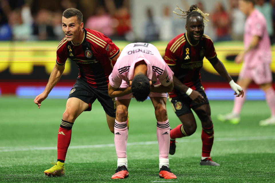 ATLANTA, GEORGIA - SEPTEMBER 16: Brooks Lennon #11 and Tristan Muyumba #8 of Atlanta United celebrate after a goal as Sergio Busquets #5 of Inter Miami CF reacts during the first half at Mercedes-Benz Stadium on September 16, 2023 in Atlanta, Georgia. (Photo by Kevin C. Cox/Getty Images)