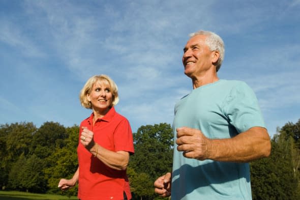 A0KARM close up of mature man and woman jogging