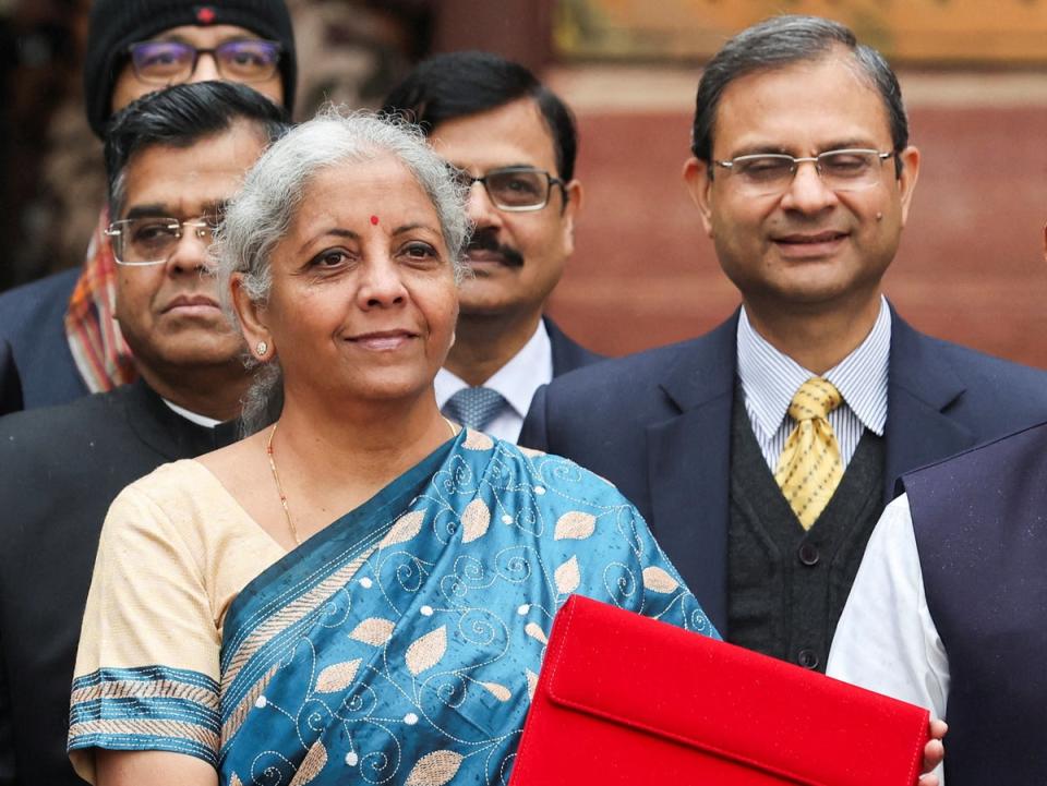 India’s finance minister Nirmala Sitharaman holds up a folder with the Government of India’s logo as she leaves her office to present the federal budget in the parliament (REUTERS)