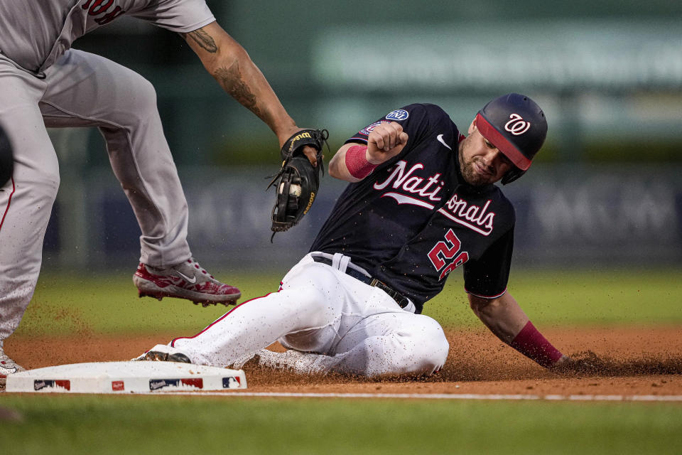 Washington Nationals' Lane Thomas (28) steals third base during the third inning of the team's baseball game against the Boston Red Sox at Nationals Park, Wednesday, Aug. 16, 2023, in Washington. (AP Photo/Andrew Harnik)