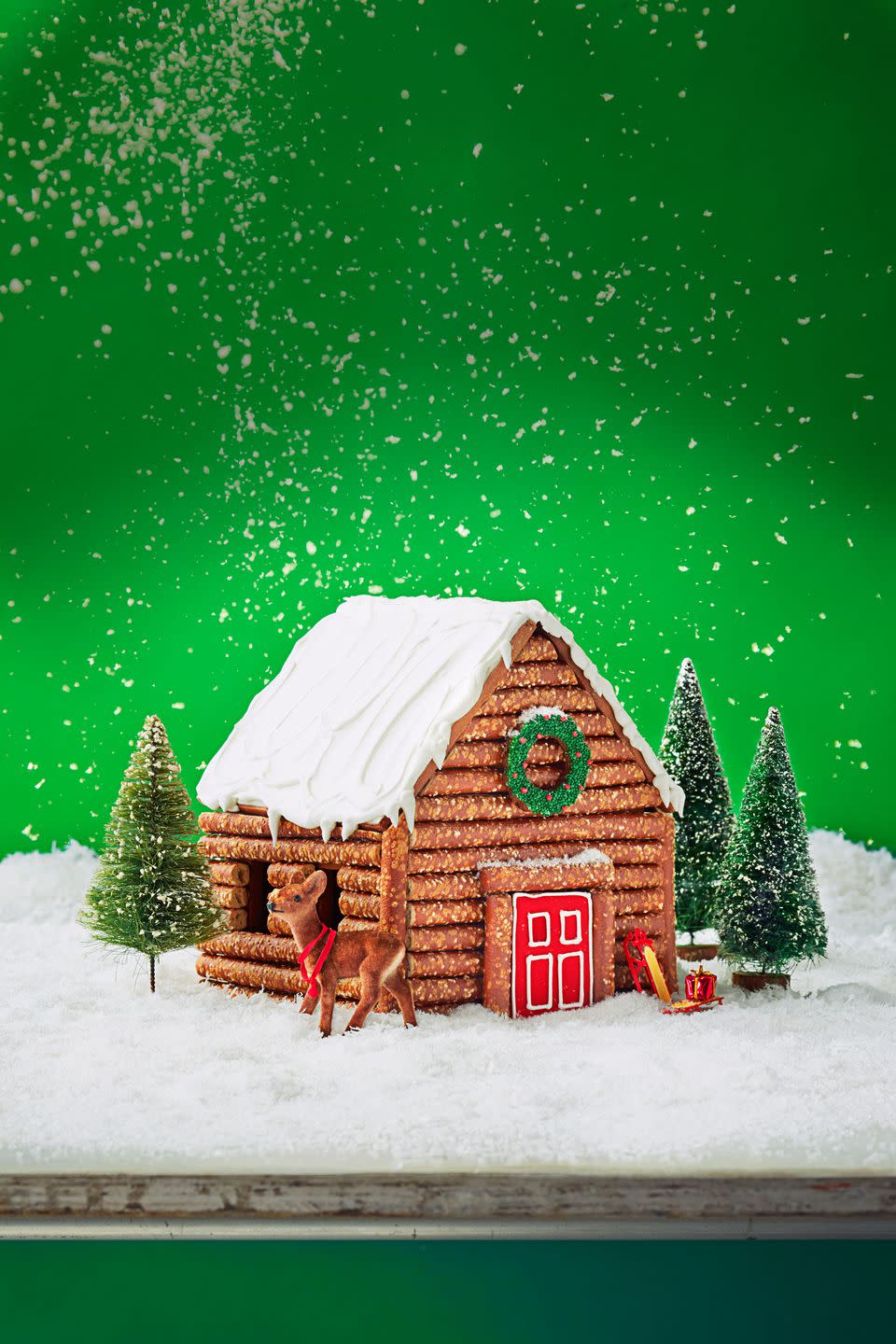 <p>Attach pretzel rods to the exterior of your gingerbread house with royal icing to create an edible log cabin! </p>