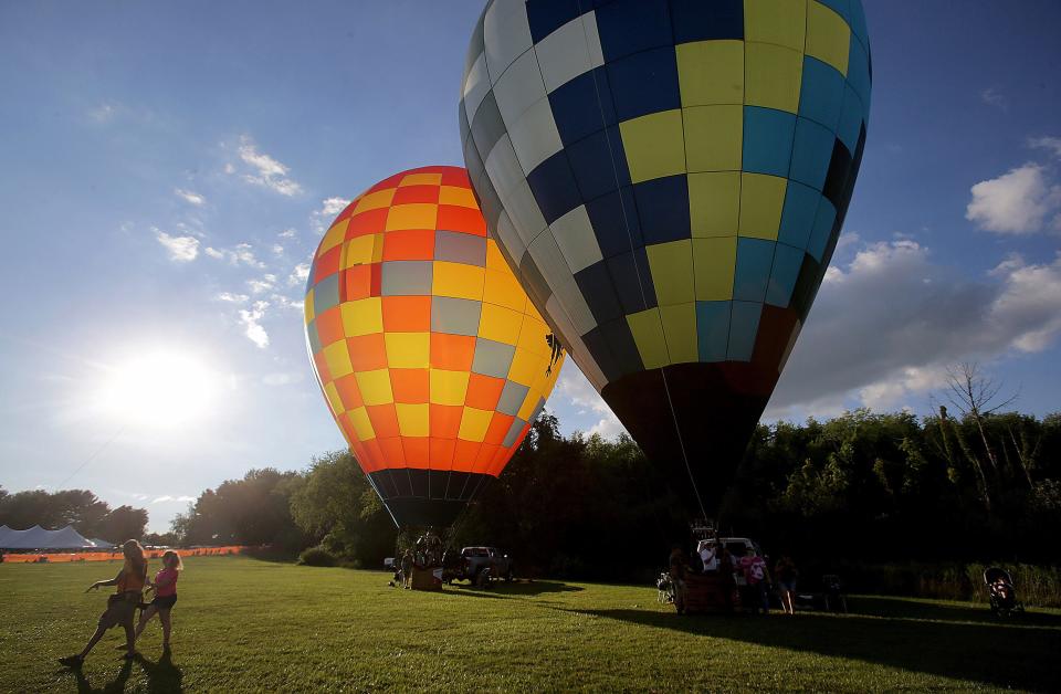 Hot-air balloons get ready to take flight Saturday during the Pro Football Hall of Fame Enshrinement Festival Balloon Classic.