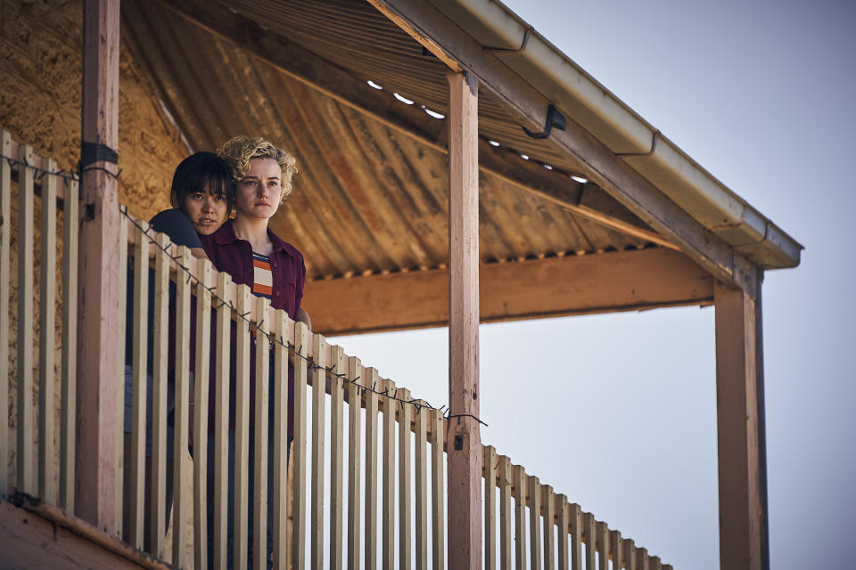 This image released by Neon shows Jessica Henwick, left, and Julia Garner in a scene from "The Royal Hotel." (Neon via AP)