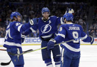 Tampa Bay Lightning center Tyler Johnson (9) celebrates his goal against the Toronto Maple Leafs with center Brayden Point (21) and defenseman Victor Hedman (77) during the second period of an NHL hockey game Thursday, Dec. 13, 2018, in Tampa, Fla. (AP Photo/Chris O'Meara)