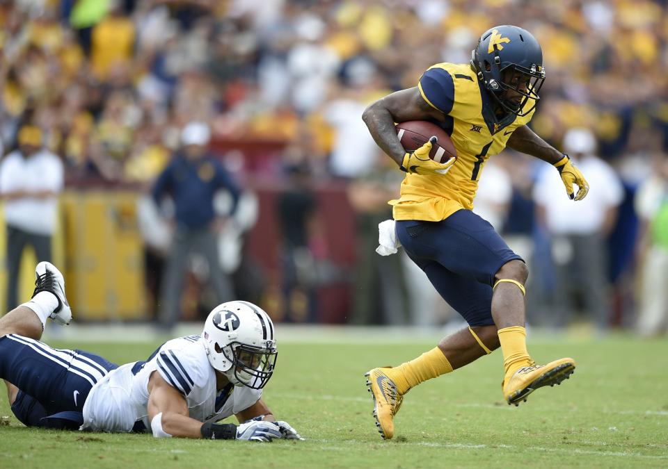 West Virginia wide receiver Shelton Gibson (1) carries the ball past BYU defensive back Eric Takenaka Saturday, Sept. 24, 2016, in Landover, Md. | Nick Wass, Associated Press