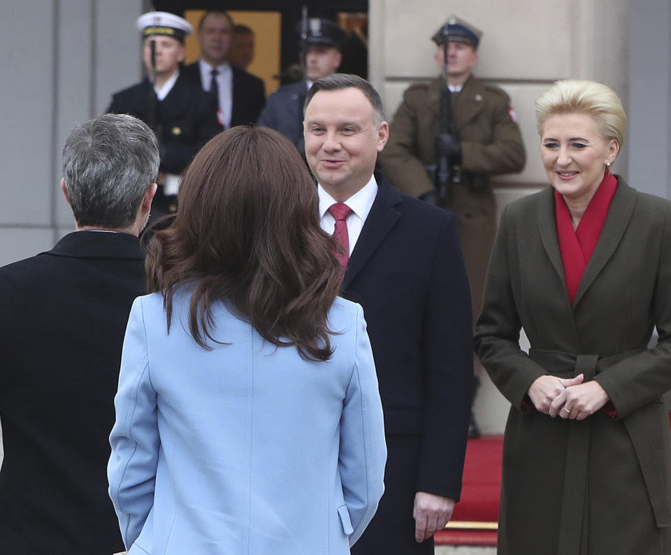 Denmark's Crown Prince Frederik, left, and Crown Princess Mary, second from left, welcome by, Poland's President Andrzej Duda, second from right, and his wife Agata Kornhauser-Duda, right, during welcoming ceremony at the start of their one-day visit marking 100 years of bilateral relations, in the Presidential Palace in Warsaw, Poland, Monday, Nov. 25, 2019.(AP Photo/Czarek Sokolowski)