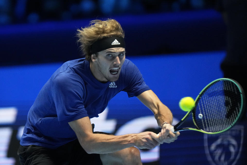 Alexander Zverev of Germany returns with a backhand to Daniil Medvedev of Russia during their singles final tennis match of the ATP World Tour Finals, at the Pala Alpitour in Turin, Italy, Sunday, Nov. 21, 2021. (AP Photo/Luca Bruno)