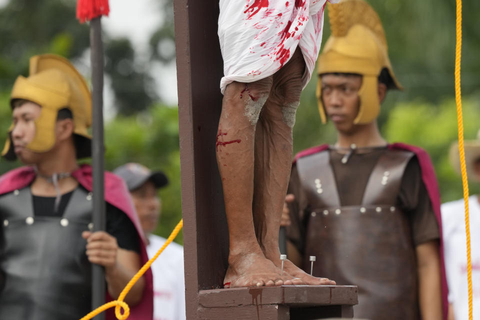 A nail is seen in the feet of Wilfredo Salvador during a reenactment of Jesus Christ's sufferings as part of Good Friday rituals April 7, 2023 in the village of San Pedro, Cutud, Pampanga province, northern Philippines. The real-life crucifixions, a gory Good Friday tradition that is rejected by the Catholic church, resumes in this farming village after a three-year pause due to the coronavirus pandemic.(AP Photo/Aaron Favila)