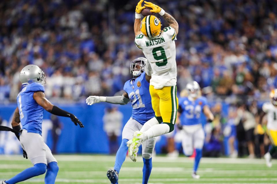 Green Bay Packers receiver Christian Watson makes a leaping 53-yard catch on the first play of the game against Detroit Lions safety Tracy Walker III (21) on Nov. 23.