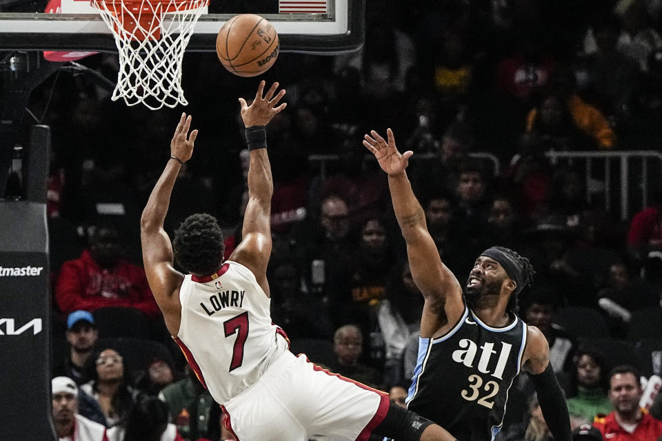 Miami Heat guard Kyle Lowry (7) shoots against Atlanta Hawks guard Wesley Matthews (32) during the first half of an NBA basketball game, Saturday, Nov. 11, 2023, in Atlanta. (AP Photo/Mike Stewart)