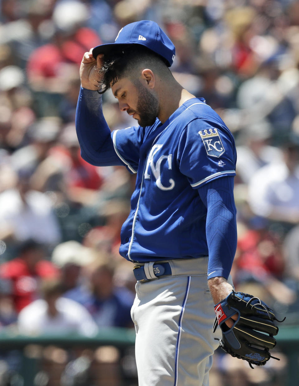 Kansas City Royals starting pitcher Jakob Junis adjusts his cap in the fourth inning in a baseball game against the Cleveland Indians, Wednesday, June 26, 2019, in Cleveland. (AP Photo/Tony Dejak)