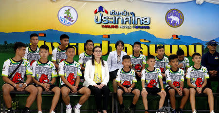 The 12 boys and their soccer coach who were rescued from a flooded cave arrive for a news conference in the northern province of Chiang Rai, Thailand, July 18, 2018. REUTERS/Soe Zeya Tun/Files