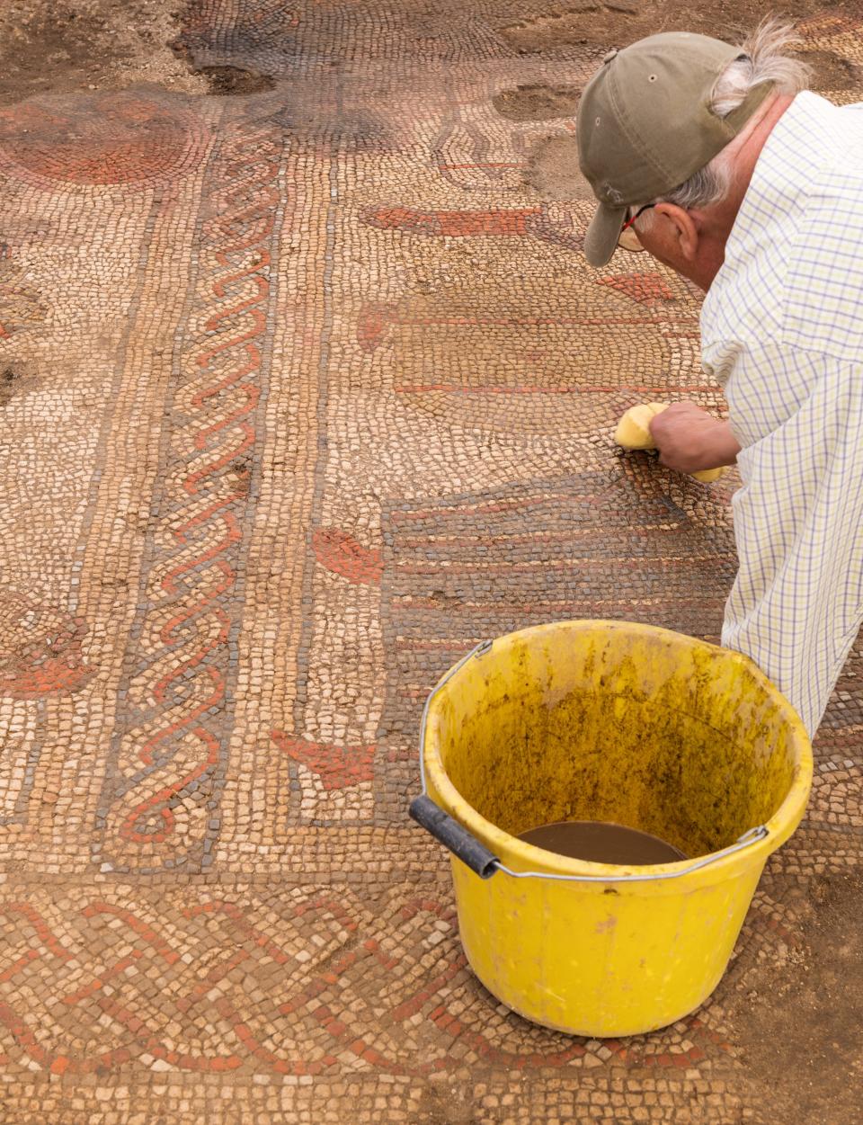 A member of the team from ULAS/University of Leicester during the excavations of a mosaic pavement.