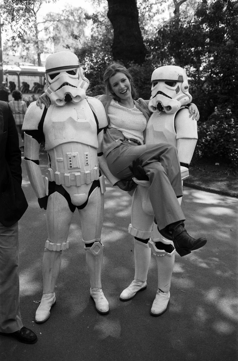 The stars of 'Star Wars: Episode V û The Empire Strikes Back' attend a photocall outside the Savoy Hotel, actress Carrie Fisher with the Stormtroopers, 19th May 1980. (Photo by Alisdair MacDonald/Daily Mirror/Mirrorpix/Getty Images)