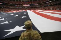 <p>A member of the military holds a giant American flat during the national anthem before the first half of an NFL football game between the Atlanta Falcons and the Tampa Bay Buccaneers, Sunday, Sept. 11, 2016, in Atlanta. (AP Photo/David Goldman) </p>