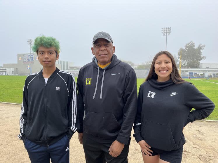 Israel Hernández (izq.), el entrenador Raymond Eason (centro) y Celeste Ortega, parte del equipo de Garfield High que correrá bajo Students Run LA el Maratón de Los Ángeles este domingo.
