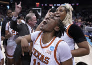 Texas guard Joanne Allen-Taylor, center, reacts after Texas beat Ohio State 66-63 in a college basketball game in the Sweet 16 round of the NCAA tournament, Friday, March 25, 2022, in Spokane, Wash. (AP Photo/Ted S. Warren)