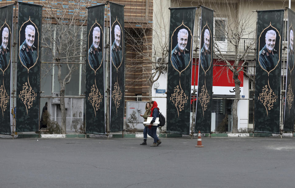 Pedestrians walk past banners showing portraits of Iranian Revolutionary Guard Gen. Qassem Soleimani, who was killed in a U.S. airstrike in Iraq, in Tehran, Iran, Saturday, Jan. 4, 2020. (AP Photo/Vahid Salemi)