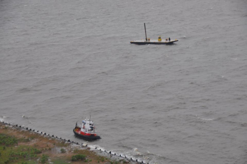 In this image provided by the U.S. Coast Guard the uninspected towing vessel Todd Michael is grounded on Lake Pontchartrain, Tuesday April 15, 2014. The Coast Guard rescued three crewmembers from the vessel after the Todd Michael took on water, separated from the barge and grounded onshore. (AP Photo/U.S. Coast Guard Air Station New Orleans)