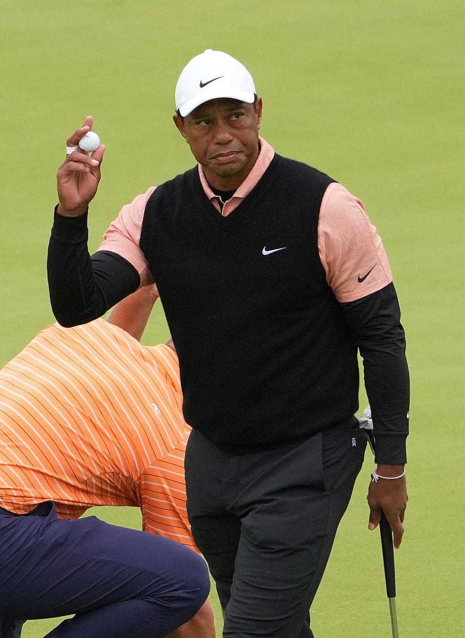 Tiger Woods acknowledges the crowd Saturday after finishing up on the 18th green during the third round of the PGA Championship at Southern Hills Country Club in Tulsa, Oklahoma.