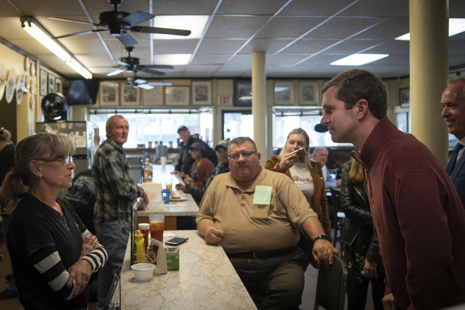 Kentucky Attorney General and Democratic gubernatorial candidate Andy Beshear listens to voters during a campaign stop at Wagner's Pharmacy, on Election Day, Tuesday, Nov. 5, 2019, in Louisville, Ky. (AP Photo/Bryan Woolston)
