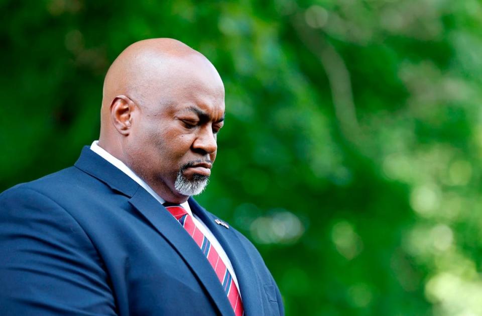 Lt. Gov. Mark Robinson bows his head during the opening prayer at a Moms for Liberty rally outside the Legislative Building in Raleigh, N.C., Wednesday, June 12, 2024.