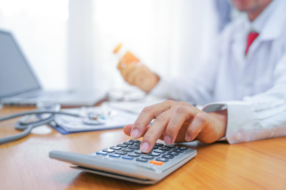 Calculate drug cost.,doctor is calculating cost of treatment