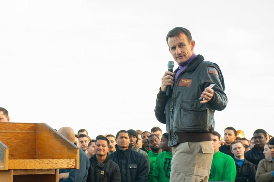 Capt. Brett Crozier, commanding officer of the aircraft carrier USS Theodore Roosevelt (CVN 71), gives remarks during an all-hands call on the ship’s flight deck Dec. 15, 2019.