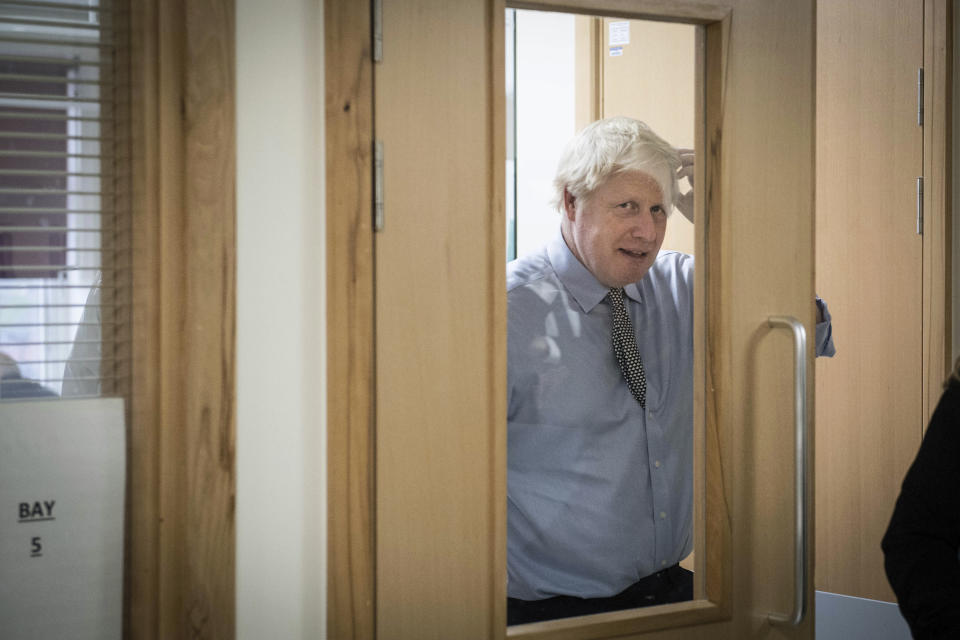 Britain's Prime Minister Boris Johnson gestures, during a visit to Bassetlaw District General Hospital, while on the campaign trail for the General Election, in Worksop, Nottinghamshire, England, Friday, Nov. 22, 2019. Britain goes to the polls on Dec. 12. (Stefan Rousseau/PA via AP)