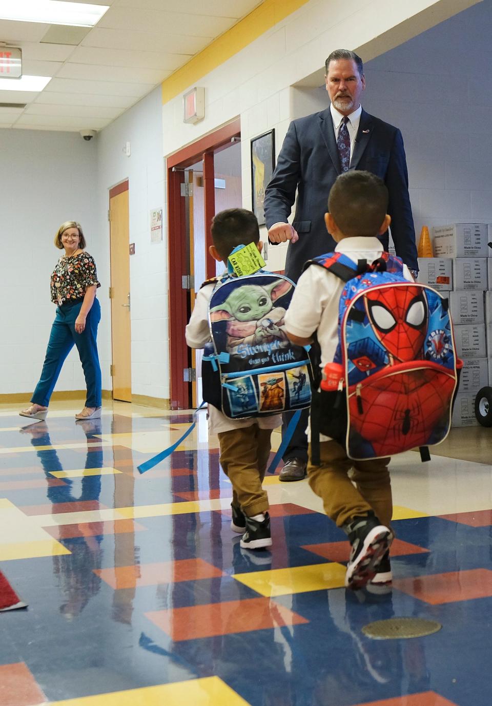 Sean McDaniel, Oklahoma City superintendent, offers a fist bump to two Cesar Chavez Elementary School students Thursday, Aug. 11 2022, as they leave on the first day of school.