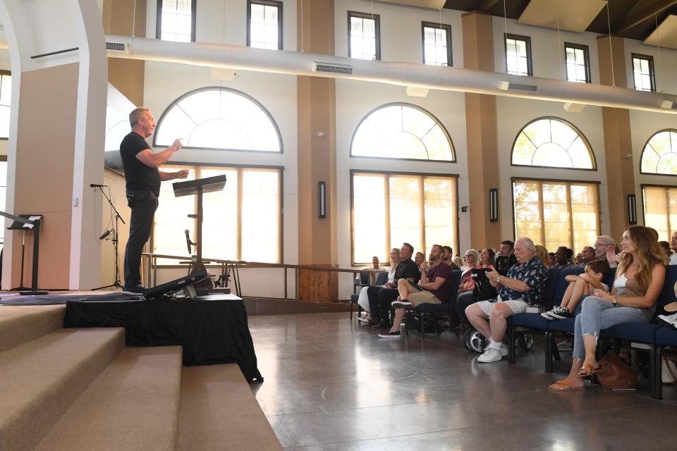 Pastor Rob McCoy, leader of Godspeak Calvary Chapel in Newbury Park, speaks to a packed room Aug. 21. The controversial pastor joined as co-chair national conservative organization Turning Point Faith.