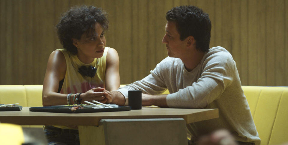 This image released by Netflix shows Jurnee Smollett, left, and Miles Teller in a scene from "Spiderhead." (Netflix via AP)