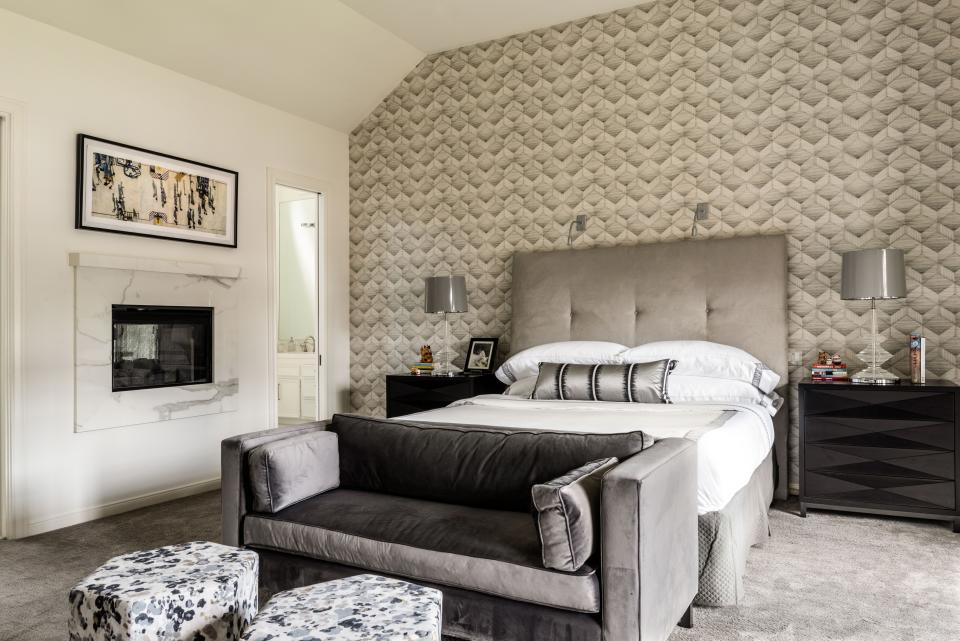 The main bedroom doubles as a hangout for the grown-ups of the home, so it’s generous enough to hold a bedside fireplace plus a sitting area with a television. The geometric wallpaper provides the black-and-white anchor that has become Lucinda Loya’s signature.