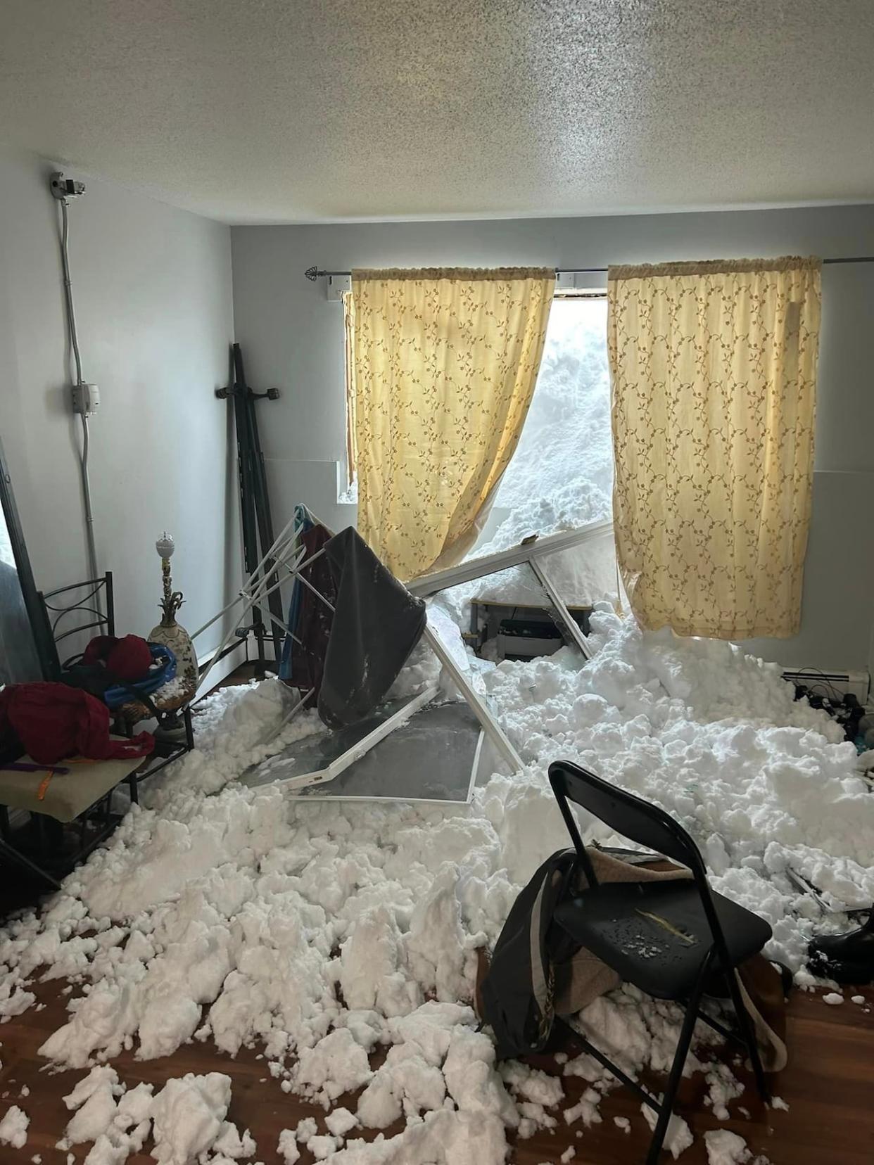 This was the view Sunday afternoon from Bedi Singh's Sydney, N.S., apartment. Huge snowfall accumulated outside of his ground-floor unit and broke windows. The same thing happened to other units in the building. (Bedi Singh/Facebook - image credit)