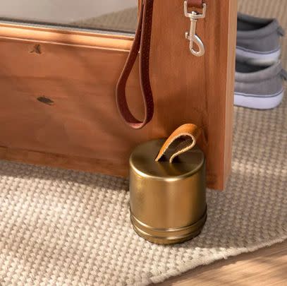 A metal and leather door stop
