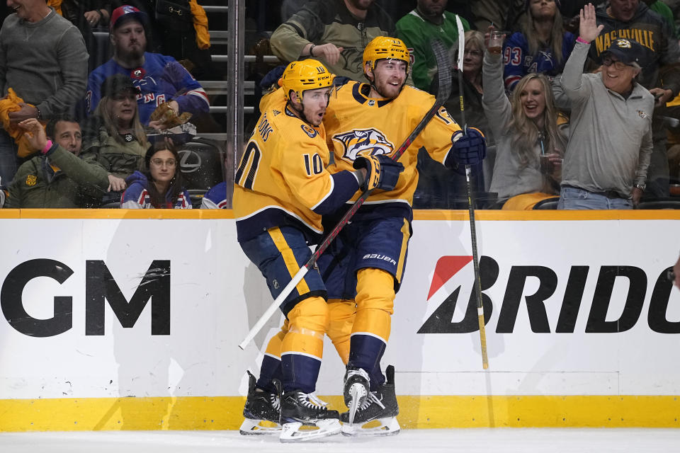 Nashville Predators center Colton Sissons (10) celebrates a short handed goal with center Yakov Trenin (13) with during the second period of an NHL hockey game against the New York Rangers, Saturday, Dec. 2, 2023, in Nashville, Tenn. (AP Photo/George Walker IV)