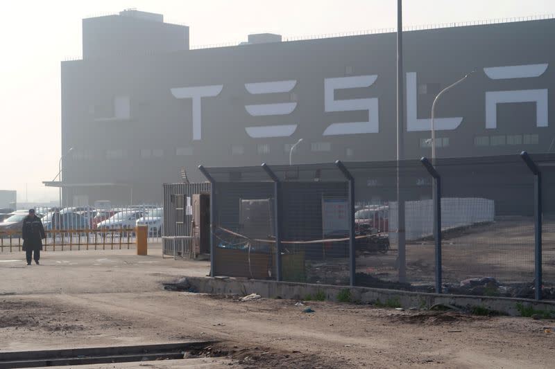 FILE PHOTO: A Tesla sign is seen on the Shanghai Gigafactory of the U.S. electric car maker